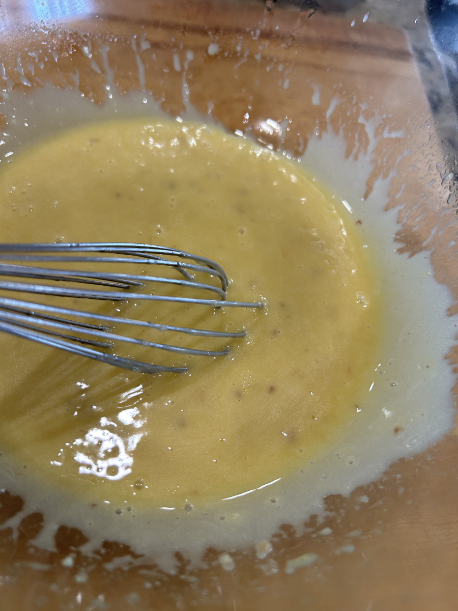 Caesar Salad Dressing - dressing whisked in a glass bowl