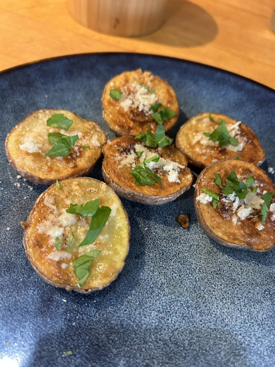 Garlic Parmesan New Potatoes - Browned new potatoes topped with salt, pepper, garlic, and parsley.