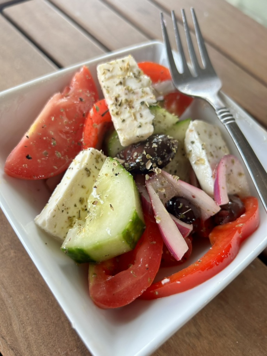 Greek Salad - tomatoes, onion, cucumber, olives, bell pepper, feta cheese, and oregano.