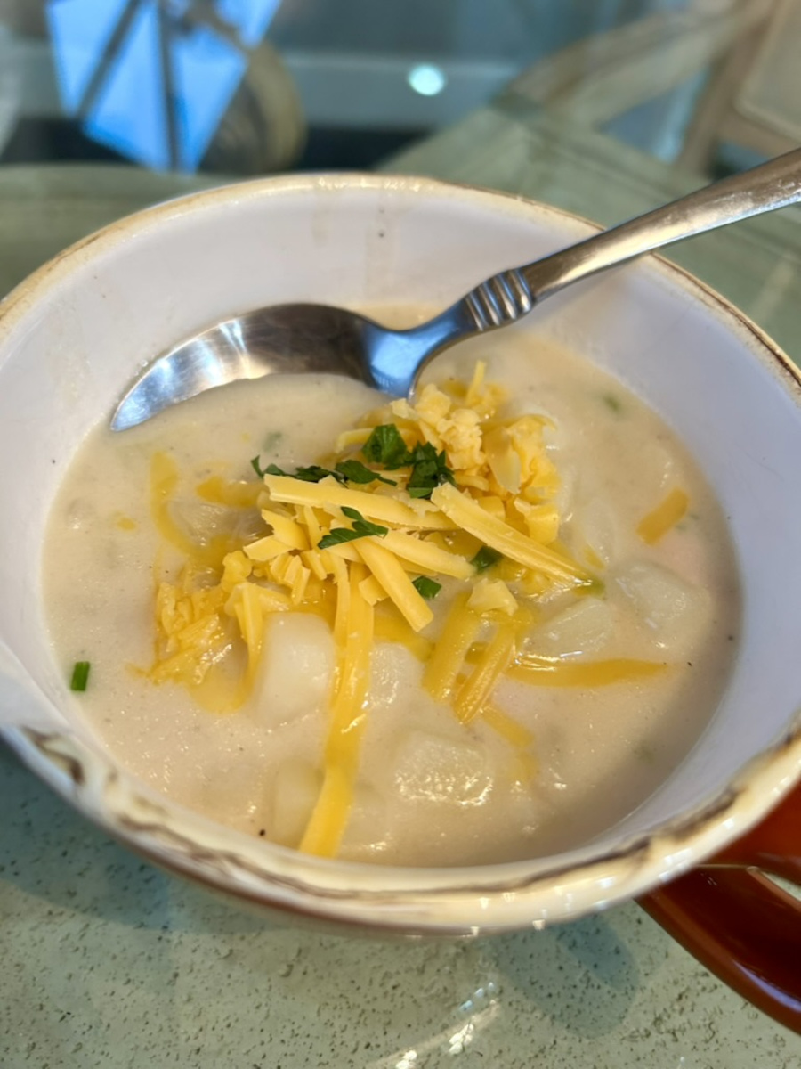 Ham and Potato Soup garnished with cheddar cheese