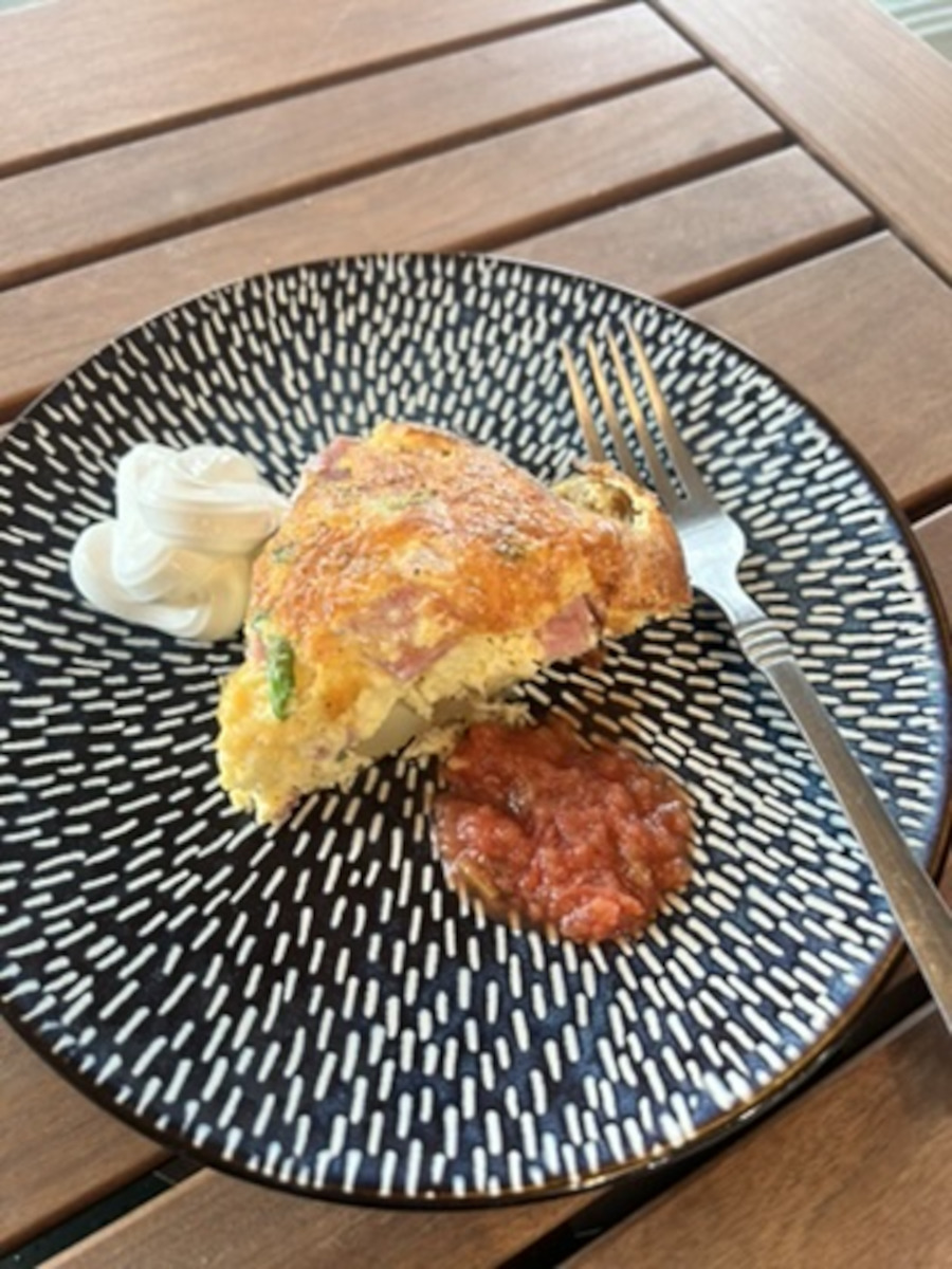 Potato Ham and Cheese Frittata - wedge served with a dollop of sour cream and some salsa picante.