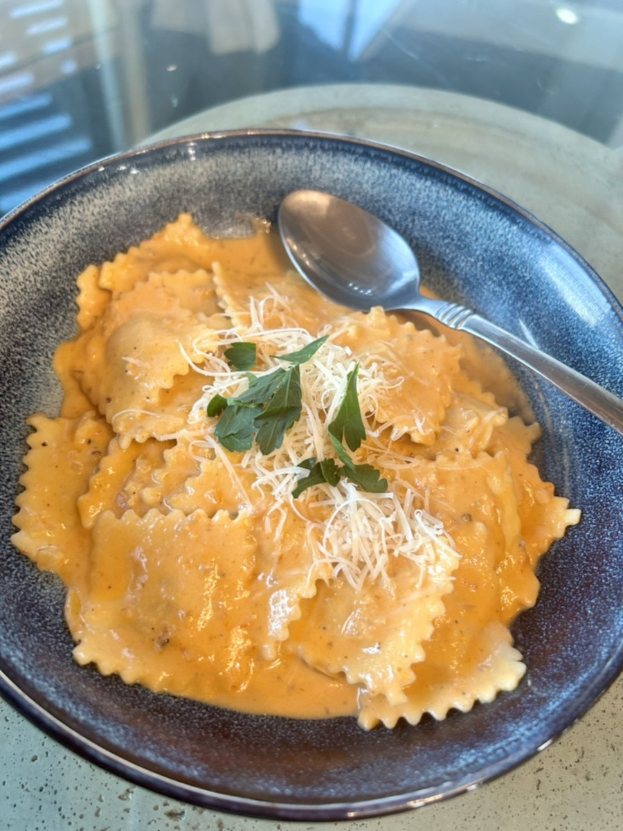 Ravioli in Vodka Sauce topped with parmesan cheese and parsley.